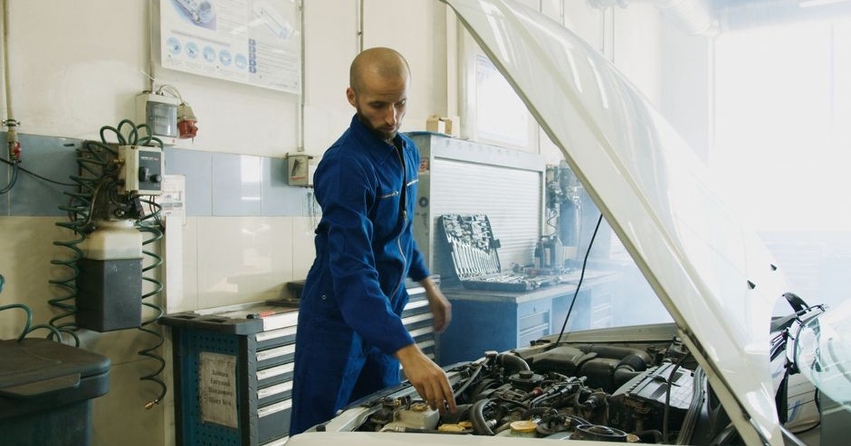 auto mechanic examining car