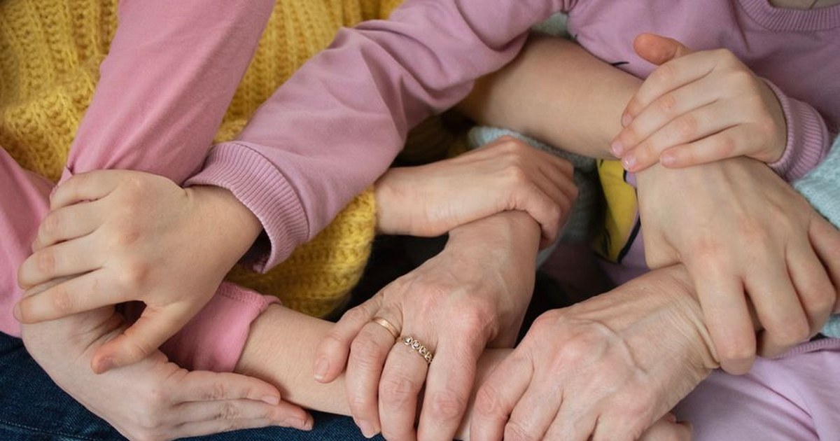 happy family holding hands together